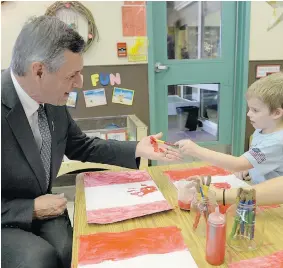  ?? DON HEALY/Leader-Post ?? Education Minister Don Morgan participat­es in a Canada Day art project with
five-year-old Boston Hickey at the Awasis Child Care Co-op, Tuesday.
