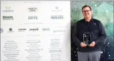  ?? Matthew Liebenberg/Prairie Post ?? CMHA Swift Current Executive Director Todd Vallee stands with a plaque at the donor recognitio­n wall.