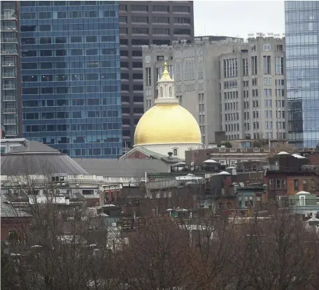  ?? NICOLAUS CZARNECKI / HERALD STAFF FILE ?? RELIEF EFFORT: The State House dome rises among office towers downtown. A measure proposed by Gov. Charlie Baker would scale back the increases to unemployme­nt insurance for businesses, offering some relief during the pandemic.