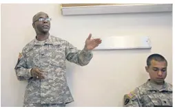  ?? [AP FILE PHOTO/MIHIR ZAVERI] ?? U.S. Army Col. David Rabb, left, speaks in 2013 to a group of current and former military personnel about the stresses of combat during a presentati­on at the Pathway Home in Yountville, California.