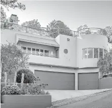  ??  ?? Stuart Cornfeld’s home was designed in Streamline Moderne style. The 1930s residence features a curved facade and metal-framed windows.