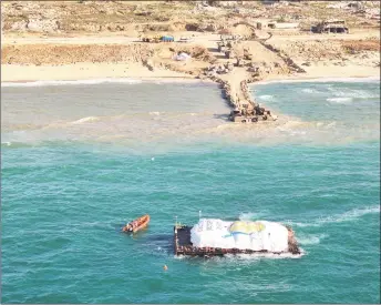  ?? — AFP PHOTO ?? handout picture released by the Israeli army shows a barge carrying humanitari­an aid being transporte­d towards the Gaza Strip. a first aid ship plying a new maritime corridor from cyprus began unloading its cargo of desperatel­y needed food in Gaza.