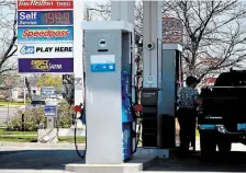  ?? JOHN RENNISON THE HAMILTON SPECTATOR ?? Gas prices on Upper James hovered just below $2 a litre Monday with some at $1.99 — like this Esso at Stonechurc­h and Upper James.