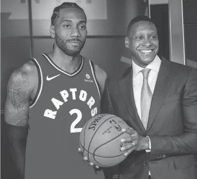  ?? ERNEST DOROSZUK / POSTMEDIA NEWS ?? Former NBA Finals MVP Kawhi Leonard and Toronto president Masai Ujiri are seen Monday as the Raptors opened training camp. The notoriousl­y tight-lipped Leonard said he comes to Toronto “with an open mind.”