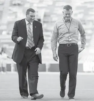  ?? AP ?? Florida coach Dan Mullen (left) walks with Gators athletic director Scott Stricklin prior to a 2018 game at Tennessee’s Neyland Stadium.