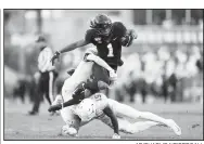  ?? AP/CHARLIE NEIBERGALL ?? Iowa State wide receiver Tarique Milton
(1) is tackled by Texas defenders D’Shawn Jamison (left) and Chris Brown after catching a pass during the first half Saturday in Ames, Iowa.