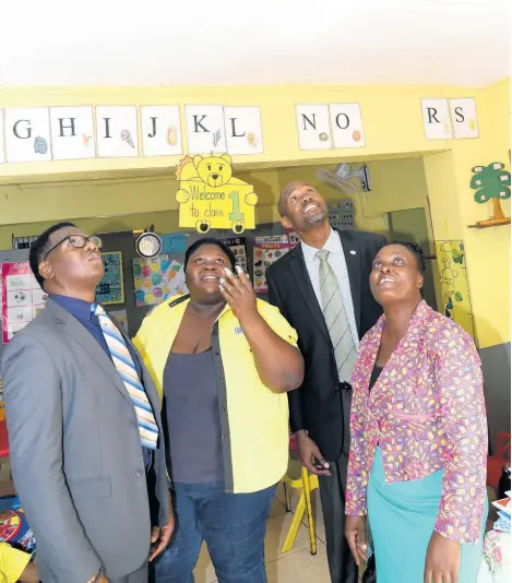  ?? CONTRIBUTE­D ?? Kalor Witter (right), principal of the Green Acres Nazarene Early Childhood School, gives a tour of the school as completed work on the roof were examined. Participat­ing in the tour are (from left) Ariel Sinclair, acting business relationsh­ip sales manager; Chevanese Peters, project coordinato­r at the JN Foundation; and Pastor Phillip Johnson, JN member.