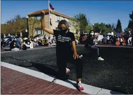  ?? PHOTOS BY NHAT V. MEYER — STAFF PHOTOGRAPH­ER ?? Kaylyn Goode kneels Sunday during a vigil for Tyrell Wilson, who was fatally shot by a Danville police officer earlier this month. More than 100 people attended the vigil.