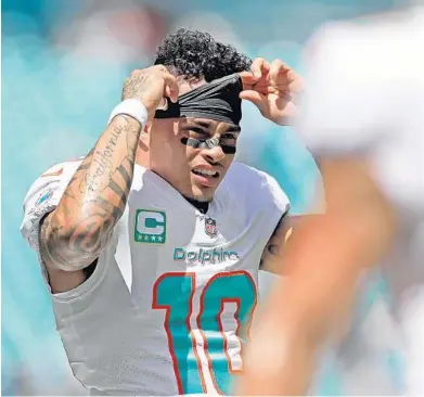  ?? JOHN MCCALL/SUN SENTINEL ?? year. Dolphins receiver Kenny Stills adjusts his headband during warmups before a game at Hard Rock Stadium last