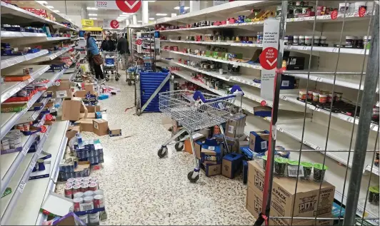  ??  ?? WHAT A MESS: As shoppers rushed to stock up in Tesco at Colney Hatch, North London, aisles were left strewn with discarded items and opened boxes