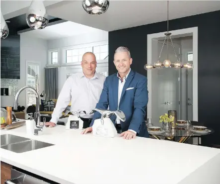  ?? DON MOLYNEAUX ?? Broadview Homes vice-president Peter-John Woolf and sales manager Bruce Staszczak in the Huntington show home in Harmony. Broadview Homes was named Builder of the Year at the 2015 Calgary region Sales and Marketing Awards.