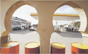  ??  ?? Fuel pumps are pictured at a gas station in Sidi Allal El Bahraoui, Morocco. Oil prices and energy shares swept higher yesterday after OPEC agreed to cut crude output to clear a glut, while the dollar and bond yields rose sharply on prospects that...