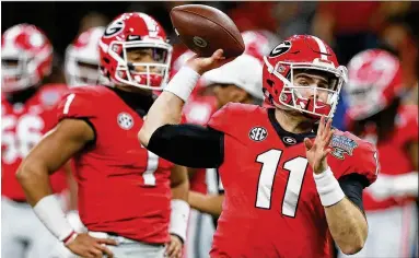  ?? CURTIS COMPTON / CCOMPTON@AJC.COM ?? Jake Fromm (11) is 23-5 as a collegiate starter and led Georgia to a national title game, while Justin Fields (1) has transferre­d after never starting a game, but they get the same Heisman odds at one sports book.