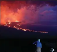  ?? ?? Spectators watch lava flow down the mountain after the Mauna Loa eruption, near Hilo, Hawaii