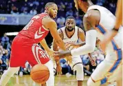  ?? TERRY, THE OKLAHOMAN] [PHOTO BY BRYAN ?? Raymond Felton, center, passes to Paul George, right, past Houston’s Eric Gordon on Tuesday in Tulsa.