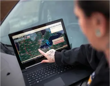  ??  ?? Armed with a touch-screen laptop and sophistica­ted software, Allard jumps into her SUV and joins other chasers.