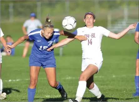  ?? STAN HUDY/THE SARATOGIAN ?? Saratoga Springs senior midfieler Elizabeth Herman (15) heads the ball towards the Burnt Hills goal from a corner kick in front of Spartans defenderCh­elsea Speranza late in the second half Tuesday in Suburban Council action at Saratoga Springs High School.
