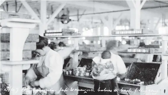  ??  ?? Japanese women with babies on their backs fill cans at the Richmond Canneries in 1913.