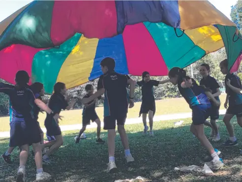  ?? Picture: ST ANDREW'S CATHOLIC COLLEGE ?? PARACHUTE GAME: Year 4 students learnt a lot and had fun on their team building day.