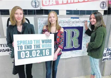  ?? [PHOTO PROVIDED] ?? From left, Samantha and Waverly Mayer remind students at Edmond North High School that the R-Word is not acceptable. Signing the banner pledging not to use the word “retard” is Adrienne Moran, a Special Olympics volunteer.