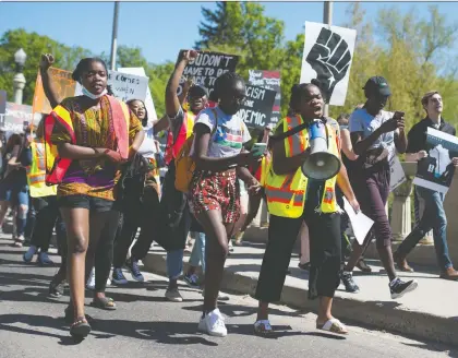  ?? PHOTOS: BRANDON HARDER ?? People march at Friday’s Black Lives Matter rally in Regina, sparked by the police-involved death of George Floyd in the U.S.