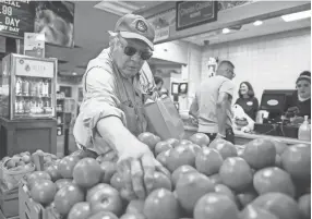  ??  ?? Jim Carter chooses Ripley tomatoes to take home from The Cupboard.