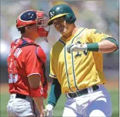  ??  ?? The Oakland A’s Ryon Healy crosses home plate after hitting a two-run home run in the first inning of Saturday’s game in Oakland. Hearly had two homers and two doubles in the A’s win.