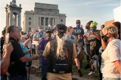  ?? Staff file photo by Danielle Dupree ?? ■ A group of protesters and counterpro­testers gather on a hot summer's evening June 19, 2020, at the nearly 103-year-old Confederat­e monument during a peaceful demonstrat­ion in favor of removing the statue from downtown Texarkana.