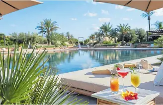  ??  ?? CALM OASIS: The pool set in beautiful gardens at the Mandarin Oriental hotel in Marrakech
