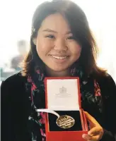  ??  ?? Quah showing the award she received from Queen Elizabeth II.