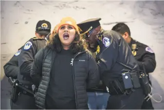  ?? Erin Schaff / New York Times ?? Police arrest a protester during a demonstrat­ion at the Capitol in Washington, D.C., over the Deferred Action for Childhood Arrivals program, which is set to be abolished by March 5.