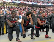  ?? PHOTO: USA TODAY ?? Eric Reid, right, kneels alongside Eli Harold and Colin Kaepernick during the US national anthem last year.