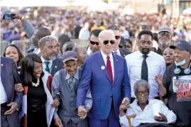  ?? AP PHOTO/PATRICK SEMANSKY ?? President Joe Biden prepares to walk across the Edmund Pettus Bridge in Selma, Ala., on Sunday to commemorat­e the 58th anniversar­y of “Bloody Sunday.” Rep. Terri Sewell, D-Ala., is second from left.