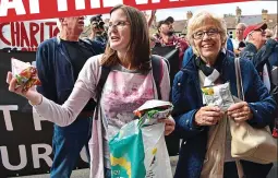  ??  ?? Munch bunch: protesters give out crisps outside The Valley