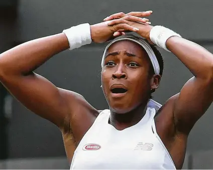  ?? Ben Stansall / AFP/Getty Images ?? The look on Cori Gauff ’s face says it all after she defeated fellow American Venus Williams on the first day of Wimbledon.
