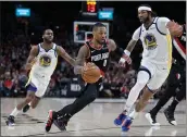  ?? CRAIG MITCHELLDY­ER — THE ASSOCIATED PRESS ?? Portland Trail Blazers guard Damian Lillard, center, dribbles between Golden State Warriors center Willie Cauley-Stein, right, and guard Alec Burks during the second half of an NBA basketball game in Portland, Ore. The Trail Blazers won 129-124in overtime.