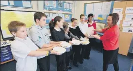  ??  ?? FUEL: Pupils at Dogsthorpe Junior School’s breakfast club get ready to start their SATS exams thanks to breakfast provided by Sainsburys. (METP-16-05-12RH3) Picture: ROWLAND HOBSON.