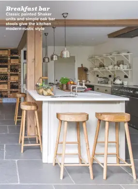  ??  ?? CLASSIC PAINTED SHAKER UNITS AND SIMPLE OAK BAR STOOLS GIVE THE KITCHEN MODERN-RUSTIC STYLE