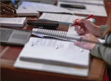  ?? RAHUL LAL — FOR CALMATTERS ?? A state senator works during session on suspense file day at the state Capitol in Sacramento on Sept. 1, 2023.