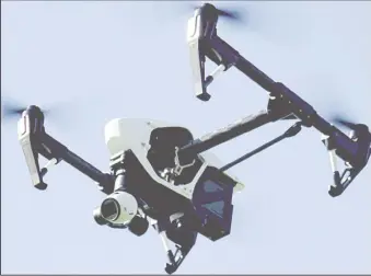  ??  ?? A camera carrying drone