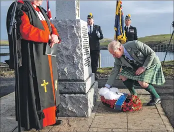  ?? Photograph­s: Warren Media. ?? Prince Charles, Lord of the Isles, lays a wreath at the Iolaire memorial on New Year’s Day.