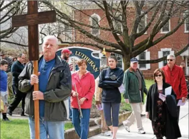 ?? MARIAN DENNIS – DIGITAL FIRST MEDIA ?? Parishione­rs from area churches participat­ed in the annual Good Friday Prayer Procession­al in observance of the holy day of obligation. Participan­ts walked to different locations in Pottstown to pray for various causes.