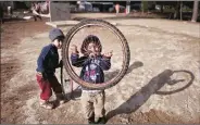  ?? AP ?? Syrian refugee children play at a refugee camp of Ritsona, about 86 km, north of Athens, Sunday.