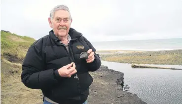 ?? PHOTO: HAMISH MACLEAN ?? Rescued . . . Volunteer David Harrowfiel­d, with help from the Waitaki District Council, has removed hundreds of artefacts from Awamoa Foreshore Reserve since the archaeolog­ical site was disturbed by the July deluge. The items will be stored at the...