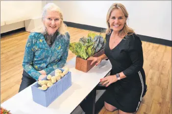  ?? SALLY COLE/THE GUARDIAN ?? Sarah Saunders, left, curator, and Alanna Jankov, executive director at The Guild, show more of the garden vegetables in the “Container Series”.