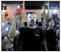  ?? AP/KIN CHEUNG ?? Masked protesters hold up their mobile phone lights Saturday as they sing a protest anthem in Hong Kong.