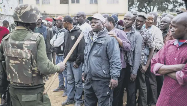  ?? PICTURE: GETTY IMAGES ?? 0 Security forces keep a watchful eye on voters at a polling station at Kariokor Community Centre in the Kenyan capital, Nairobi, yesterday