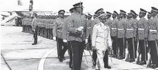 ?? GLEANER FILE PHOTO ?? His Imperial Majesty Emperor Haile Selassie inspects a guard of honour of the 1st Batallion, Jamaica Regiment at the Montego Bay Airport shortly before his departure. Escorting him is Major Leslie Lloyd.