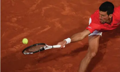  ?? Thomas Samson/AFP/Getty Images ?? Serbia's Novak Djokovic returns the ball to Spain's Rafael Nadal during their French Open quarter-final match on Tuesday. Photograph: