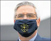  ?? MICHAEL CONROY/AP ?? Gov. Eric Holcomb, photograph­ed April 30, extended Indiana’s COVID-19 mask mandate for one month Wednesday.